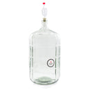 Glass carboy with an airlock and Northern Brewer temperature strip attached, used for secondary fermentation in home wine making.