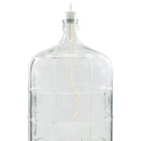 Clear glass carboy fitted with a drilled stopper and wine whip degassing tool, used to remove CO₂ from finished wine during the degassing stage of home wine making.