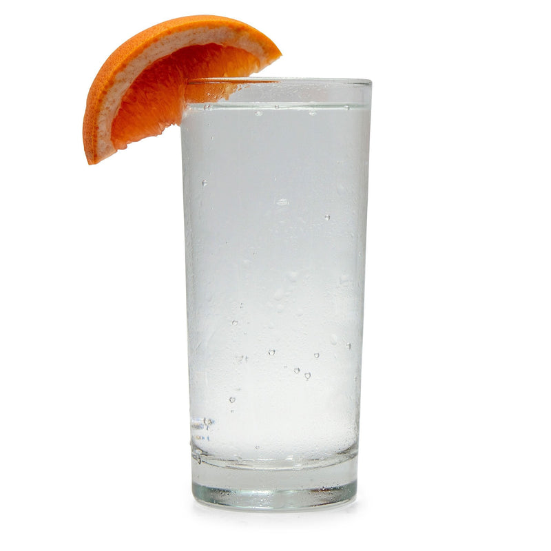 A glass of Ruby Grapefruit Hard Seltzer with a grapefruit wedge.