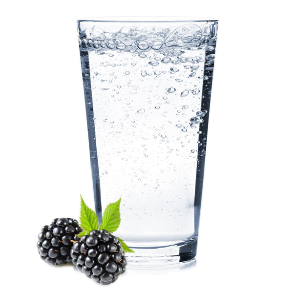 A glass of Blackberry Hard Seltzer with blackberries.