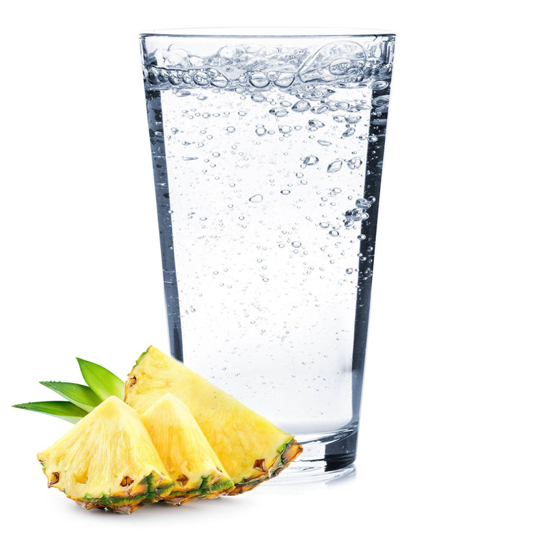 A glass of Pineapple Hard Seltzer with pineapple slices.