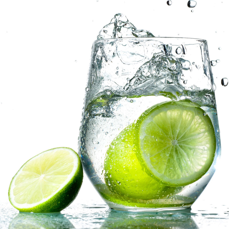 A glass of Lime Hard Seltzer with fresh lime slices.