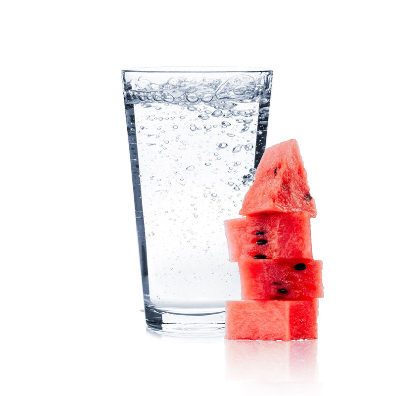 A glass of Watermelon Hard Seltzer with watermelon slices.