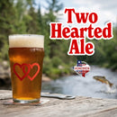 Pint of beer with two hearts on a coaster outdoors,  text overlay for Two Hearted Ale 