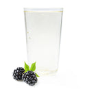 Glass of sparkling blackberry Ranch Water with fresh blackberries and green leaves on white background.