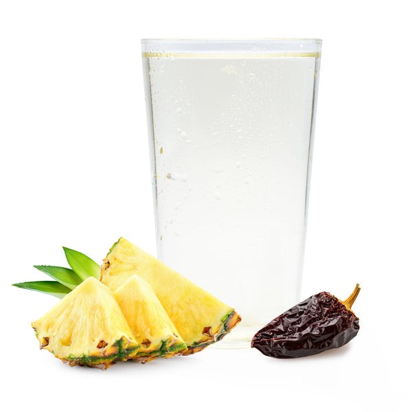 Smoky pineapple chipotle Ranch Water with pineapple chunks and dried chipotle chile next to bubbly glass.