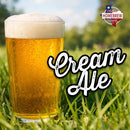 Glass of cream ale in grass with 'Cream Ale' text.