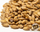 Pile of dried malt on a white background