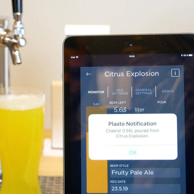 Displaying a pour notification on PLAATO app with beer faucet and full beer glass in background.